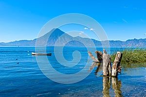 Wooden pier at Lake Atitlan on the shore at Panajachel, Guatemala.  With beautiful landscape scenery of volcanoes Toliman, Atitlan