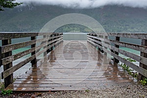 Wooden pier on Lake Bohinj at rainy, cloudy day