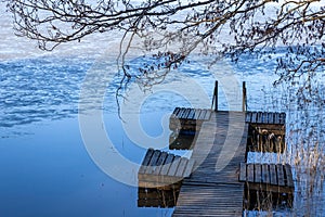 A wooden pier in a lake on a cold autumn day in southern Finland