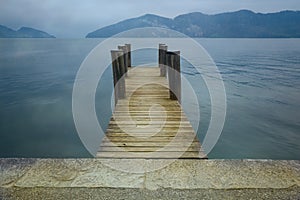 Wooden pier on lake. Vacation, tourism and adventure concept. Retro filter