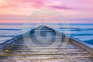 Wooden pier of Lido di Jesolo resort on sunrise Adriatic Sea Veneto Italy