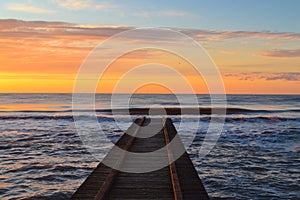 Wooden pier of Lido di Jesolo resort on sunrise Veneto Italy