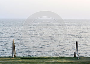 Wooden pier with metal handrails