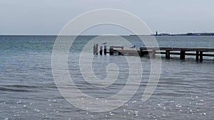 Wooden pier over sea against clear sky