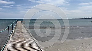 Wooden pier over sea against clear sky