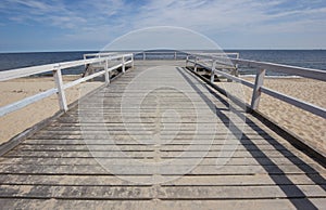 A wooden pier over the sea on lonely beach