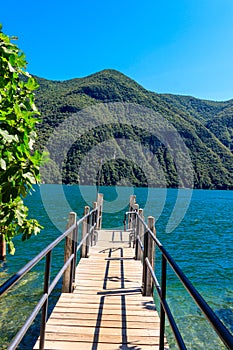 Wooden pier overlooking the Alps and Lake Lugano, Switzerland