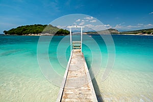 Wooden pier on paradise beach in Ksamil in Albania