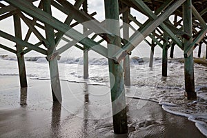 Wooden pier pilings with rusty nuts and bolts at Virginia Beach