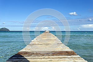 A wooden pier at Playa de Muro beach in Mallorca