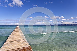 A wooden pier at Playa de Muro beach in Mallorca