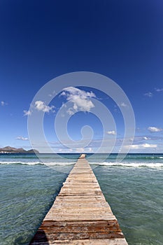 A wooden pier at Playa de Muro beach in Mallorca