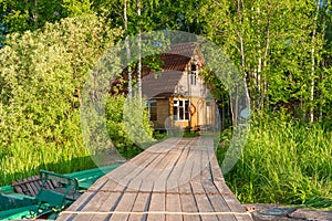 A wooden pier running from the lake to the fisherman`s house on