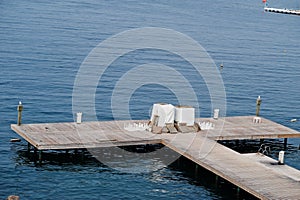 Wooden pier. Scenic landscape with mountain islands and blue lagoon on Aegean sea. Exotic scenery. Popular landmark, famous