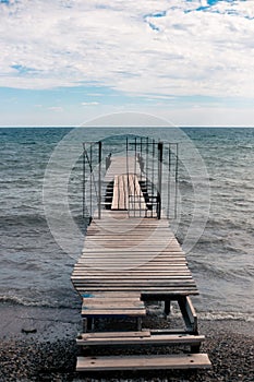 wooden pier in the sea on a cloudy day. Sea autumn landscape