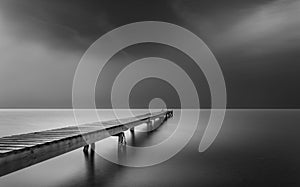 Wooden pier stretching out into the fog