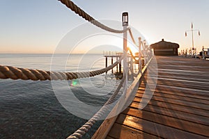 Wooden pier sun-drenched, sunset or dawn