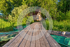 Wooden pier to the fisherman`s house on the shore