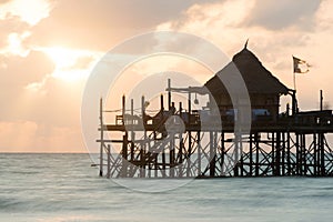 Wooden pier on a tropical beach at sunrise, Zanzibar