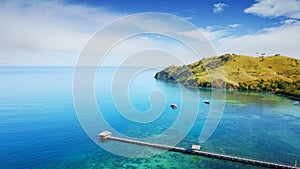 Wooden pier with turquoise water in Flores island