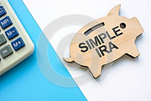 Wooden piggy bank with words SIMPLE IRA plans savings incentive match plans for employees.