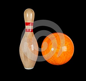 Wooden pin for bowling isolated on a black background. Bowling ball