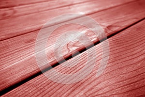 Wooden pine board surface with blur effect in red tone