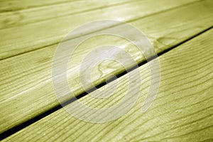 Wooden pine board surface with blur effect in yellow tone