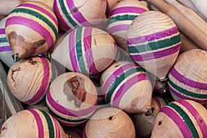 Wooden, pink-green striped classic spinning top toy. photo