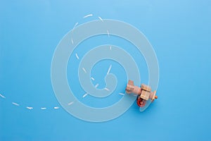 wooden plane performs a loop across the surface of a blackboard.