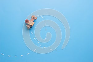 wooden plane performs a loop across the surface of a blackboard.
