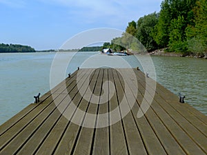 wooden plank deck in strong perspective encroaching into the river