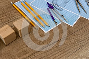 Wooden plank with drawing tools and millimeter paper