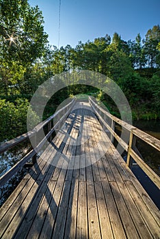 wooden plank foothpath boardwalk trampoline in the lake