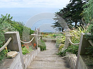Wooden plank stair descent to the sea at Mousehole Cornwall England photo