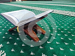 wooden plank used to put the holy book of Muslims Al-Quran. carpet background for prayer