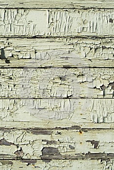 Wooden plank wall with cracked old green paint