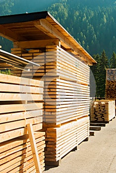 Wooden planks stacked outside an industrial woodworking