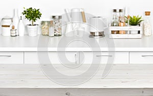 Wooden planks table over blurred image of kitchen bench interior