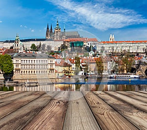 Wooden planks vith view of Prague Charles bridge