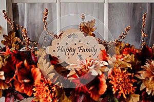 Wooden plaque with the inscription happy family among flowers