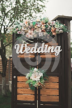 Wooden plaque with the inscription Wedding. Decorations photo