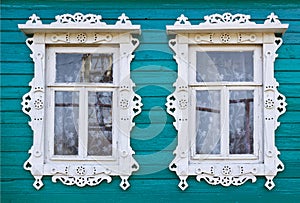 Wooden platbands on two window of an village house