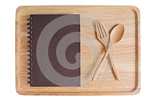 Wooden plate and empty notebook with spoon fork