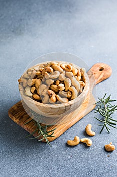wooden plate filled with cashew nuts