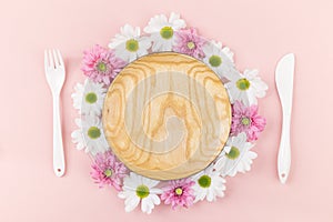 Wooden plate with flowers and tableware