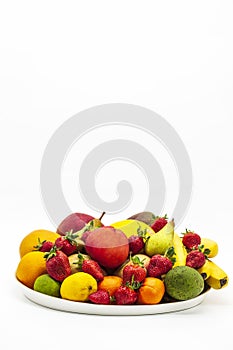 Wooden plate of fruits apple, pear, melon, mango, mandarin, banana, strawberry on a white background, isolated