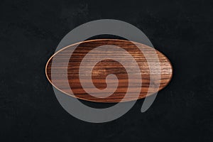 Wooden plate tray on dark stone background, top view