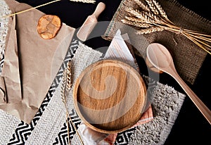 Wooden plate, tray, layout, kitchen cutlery flat lay with wheat grains. A place for branding. Natural background