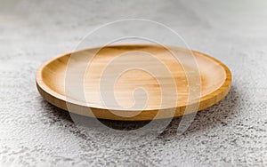 Wooden plate on a white stone background. handmade cooking utensils